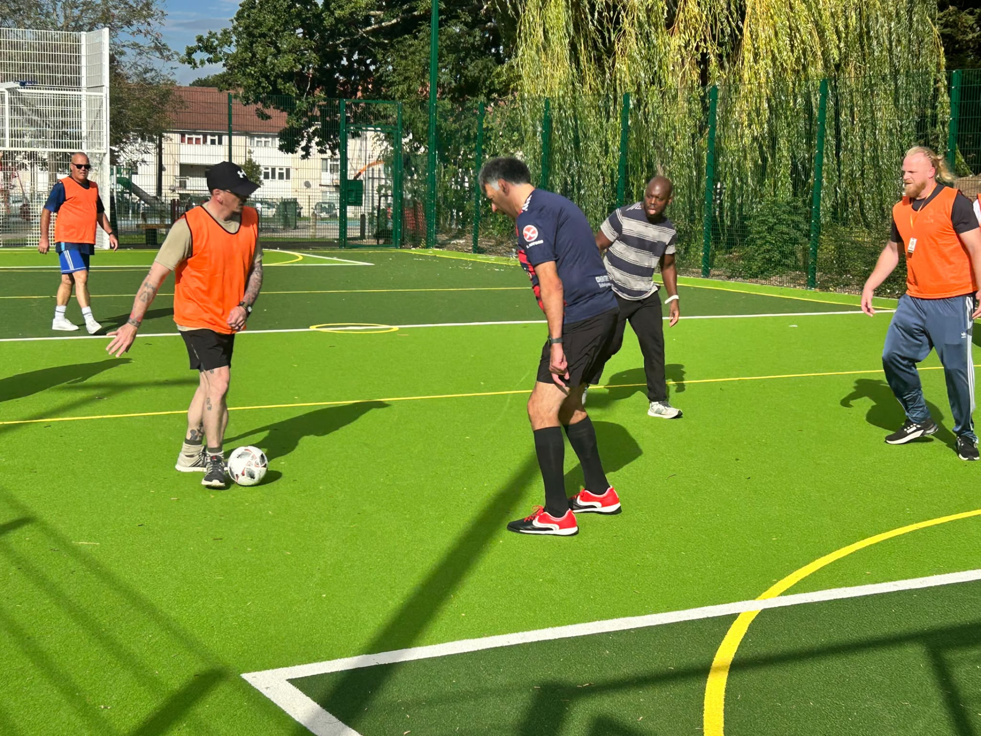 Men playing walking football on the Tile Hill MUGA pitch
