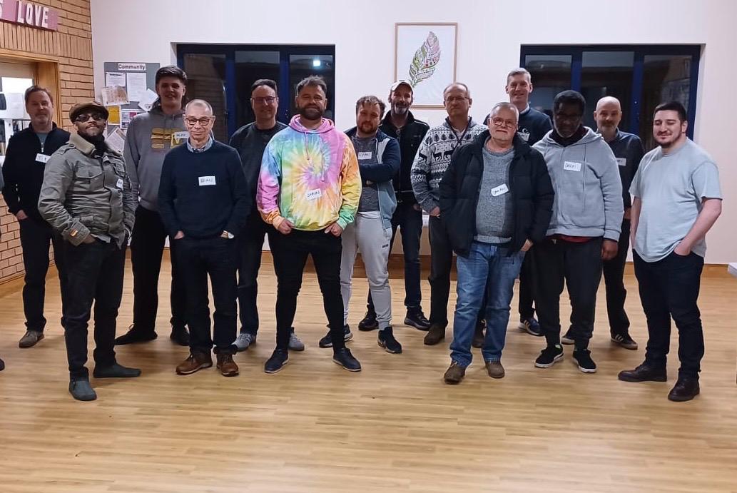 Group of men standing together at a wellbeing workshop in Coventry